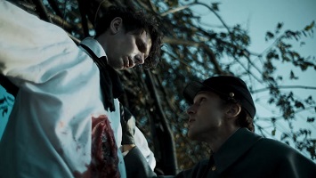 Raven's Hollow; the dead man is inspected by Cadet Edgar Poe (William Moseley).