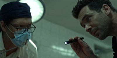 The Breach; coroner Jacob Redgrave and police chief John (Wesley French and Allan Hawco) are perplexed by the body.