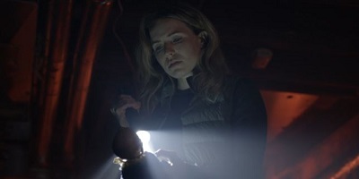 The Breach; Meg Fullbright (Emily Alatalo) finds a forgotten doll amongst the strange equipment.