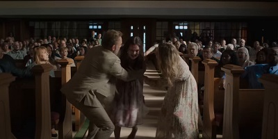 The Exorcist: Believer; her ordeal leaving her uninjured but changed, Kat (Olivia O’Neill) has to be restrained at church by her parents.
